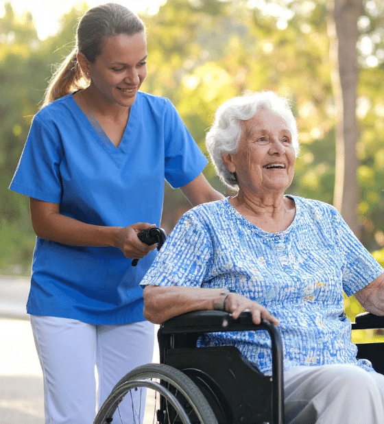 Dedicated Personal Care in Bulimba worker assisting an elderly woman with mobility support and a recreational outing.