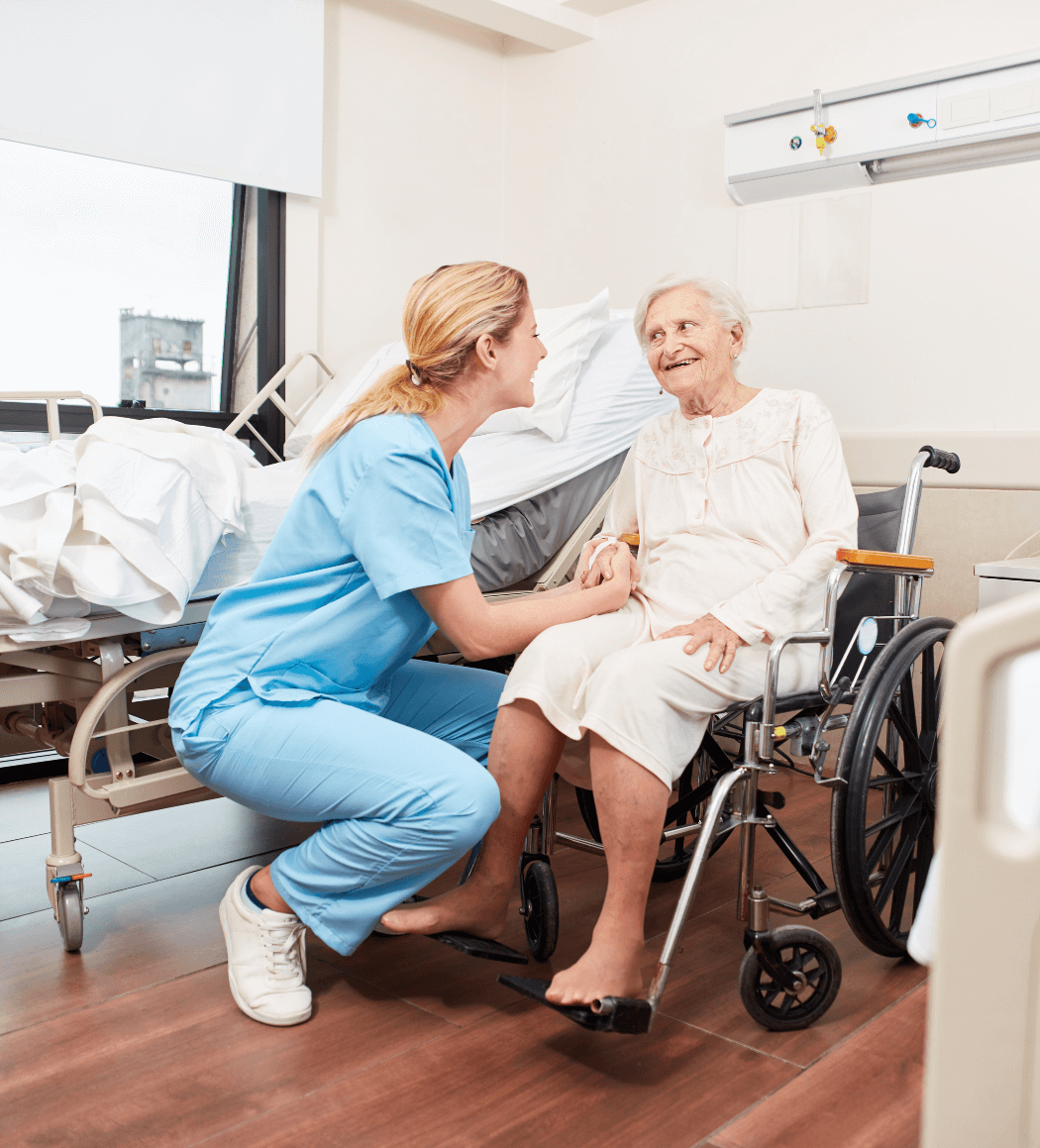 Support worker providing compassionate disability support care to an elderly woman using a wheelchair in New Farm, Brisbane.