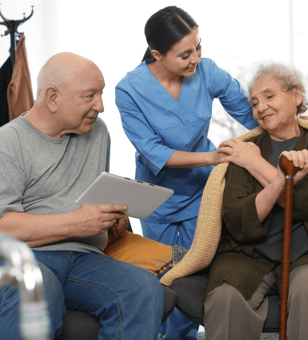 Support worker providing personal care assistance to an elderly couple at home in Paddington, Brisbane.